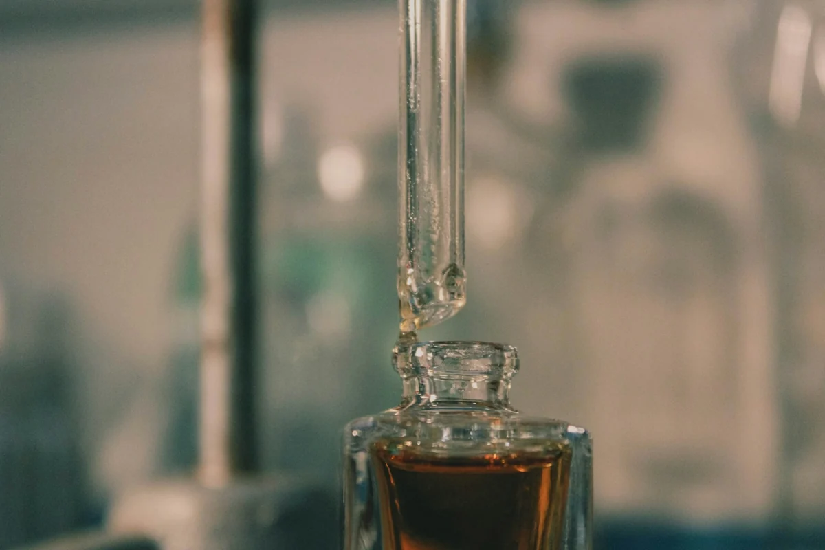 Real perfume-making detail: a glass bottle and precision dropper