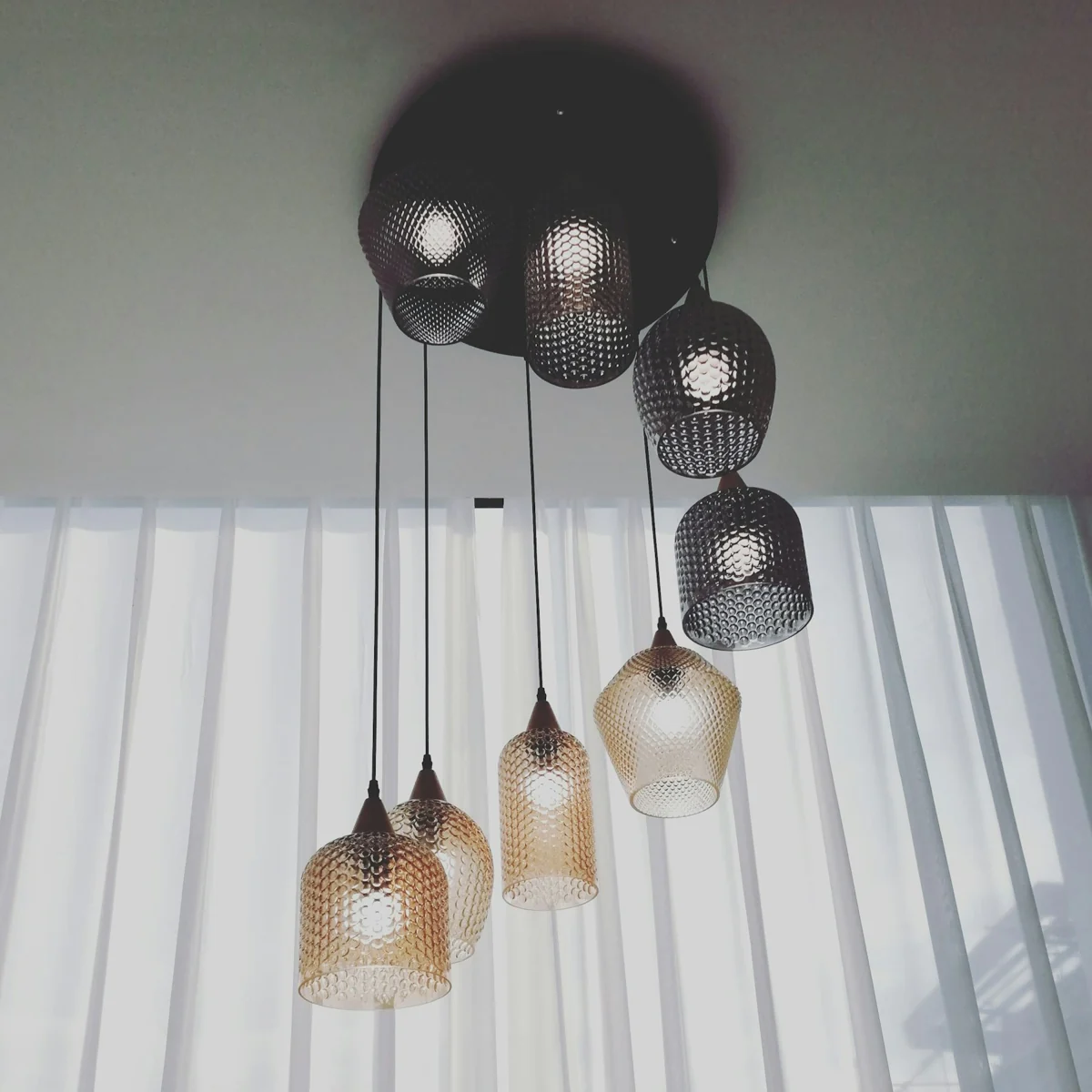 Real architectural pendant lighting with detailed textured glass and warm illumination